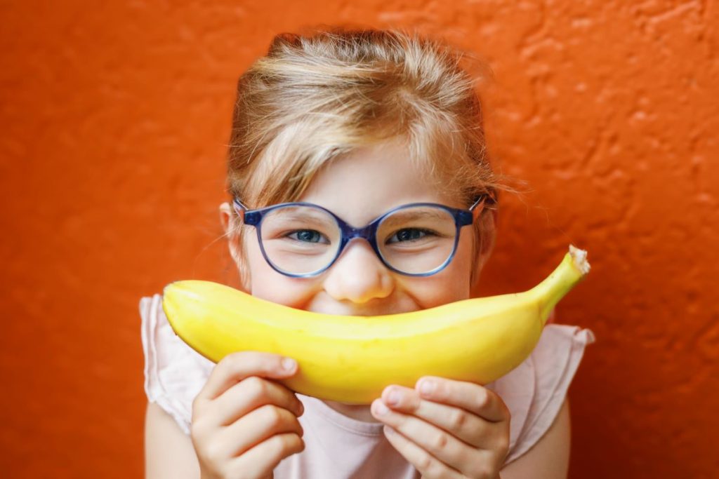 Smiling girl practicing oral nutrition and health.